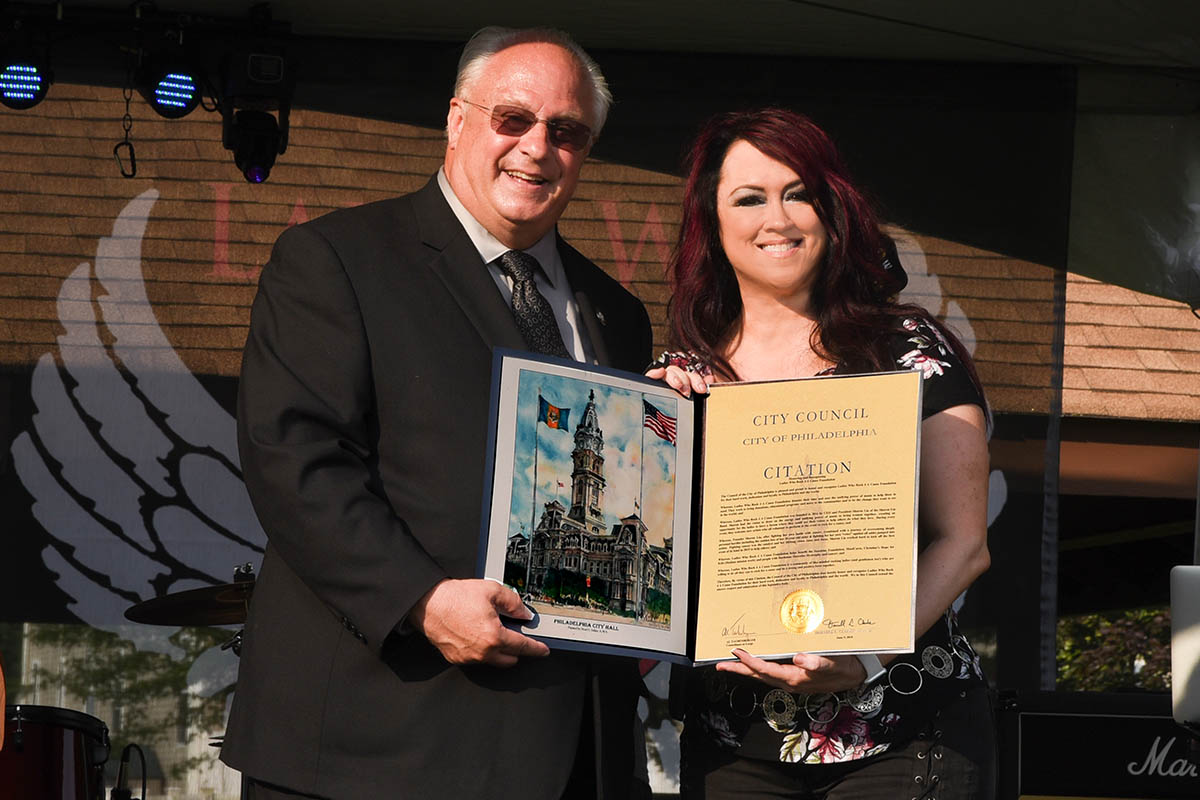 al taubenberger city councilman at large, presents official honorary citation to sharon lia of Sharon Lia Band and ceo of lwr4ac